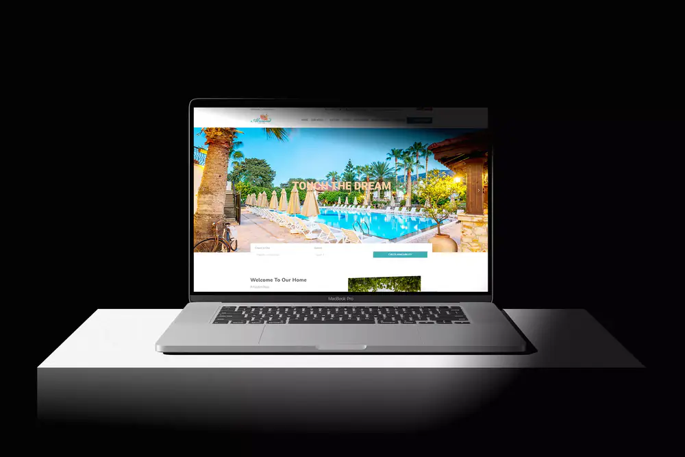 The Almond Holidays site on a laptop: poolside view and welcome heading