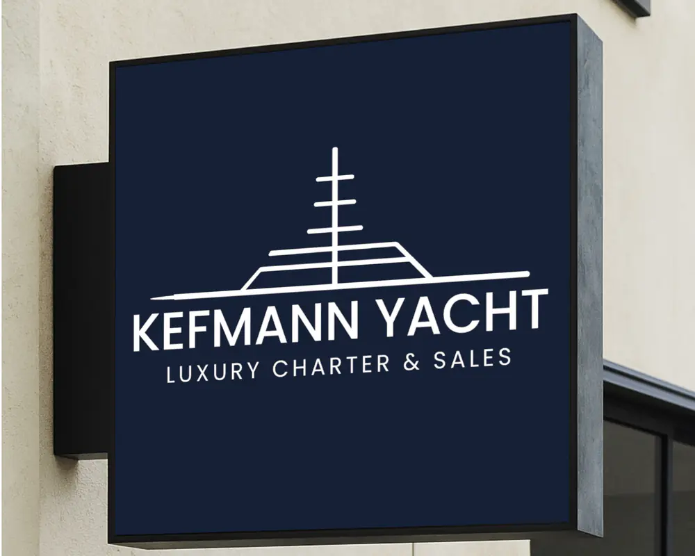 Kefmann Yacht logo on a navy wall sign