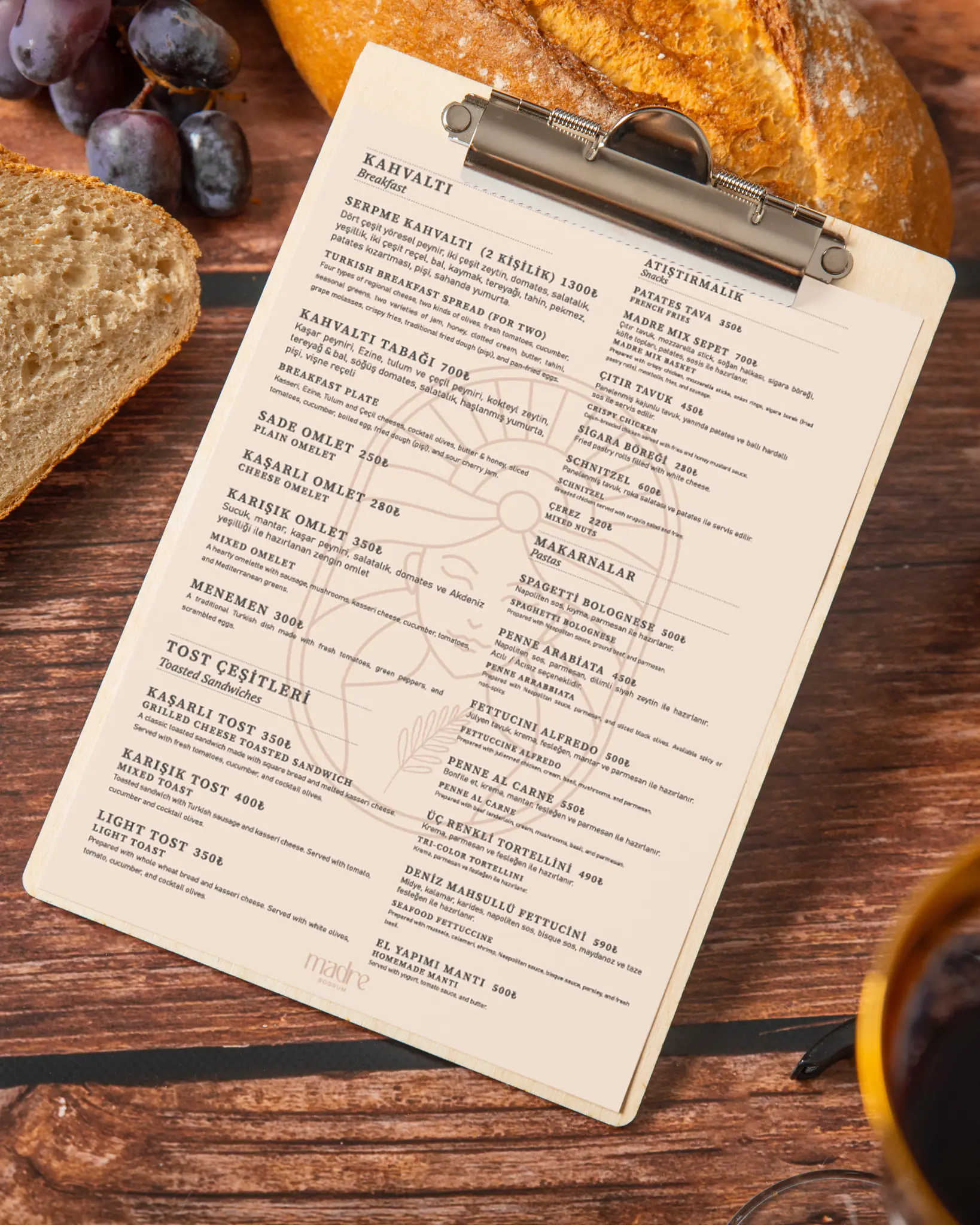 Madre Bodrum printed menu: breakfast, toasties, snacks and pasta, with the logo’s silhouette in the background